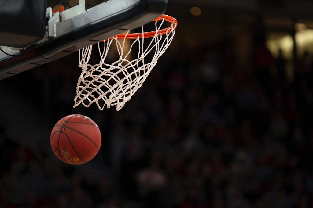 A basketball goes through the hoop