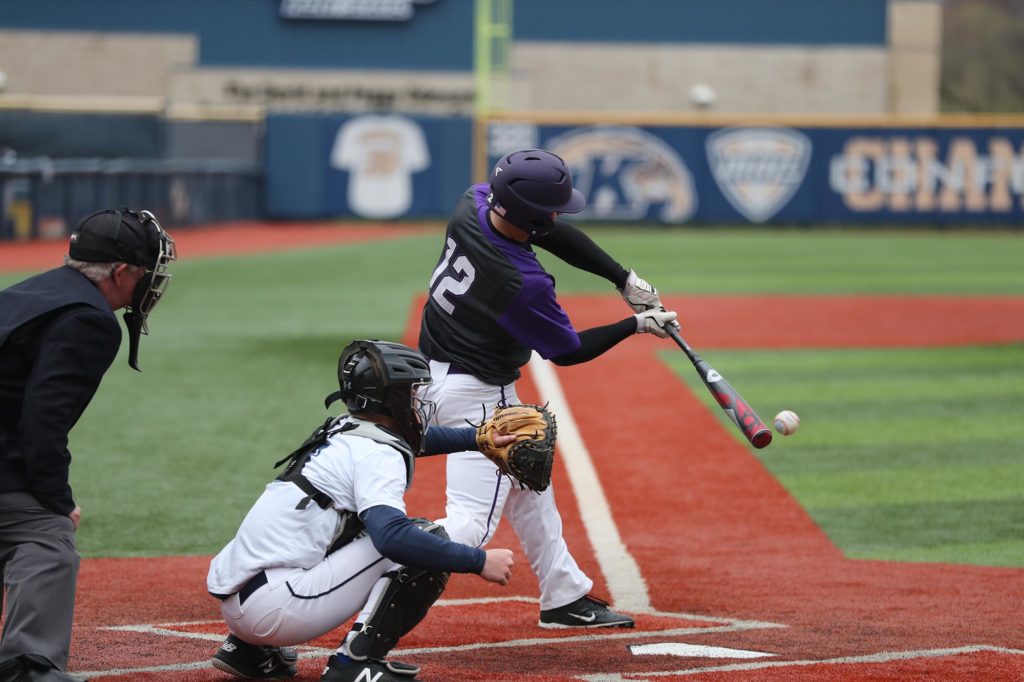 A basball player hits the ball