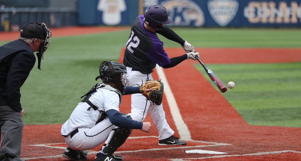 A baseball player hits the ball