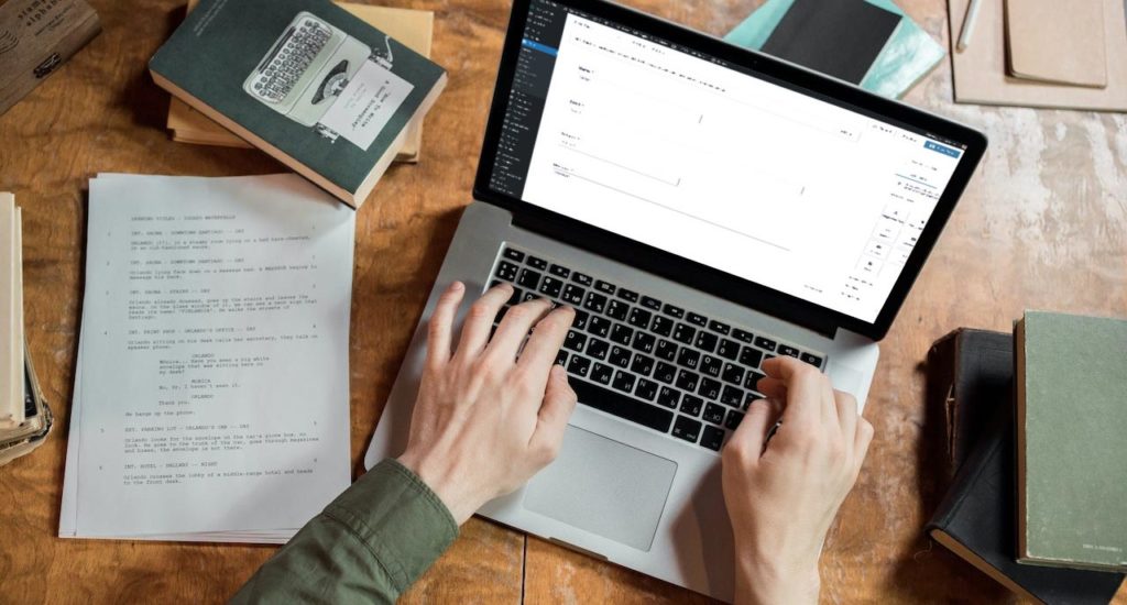 Screenshot of the Gravity Forms screen on a MacBook Pro on a wooden desk